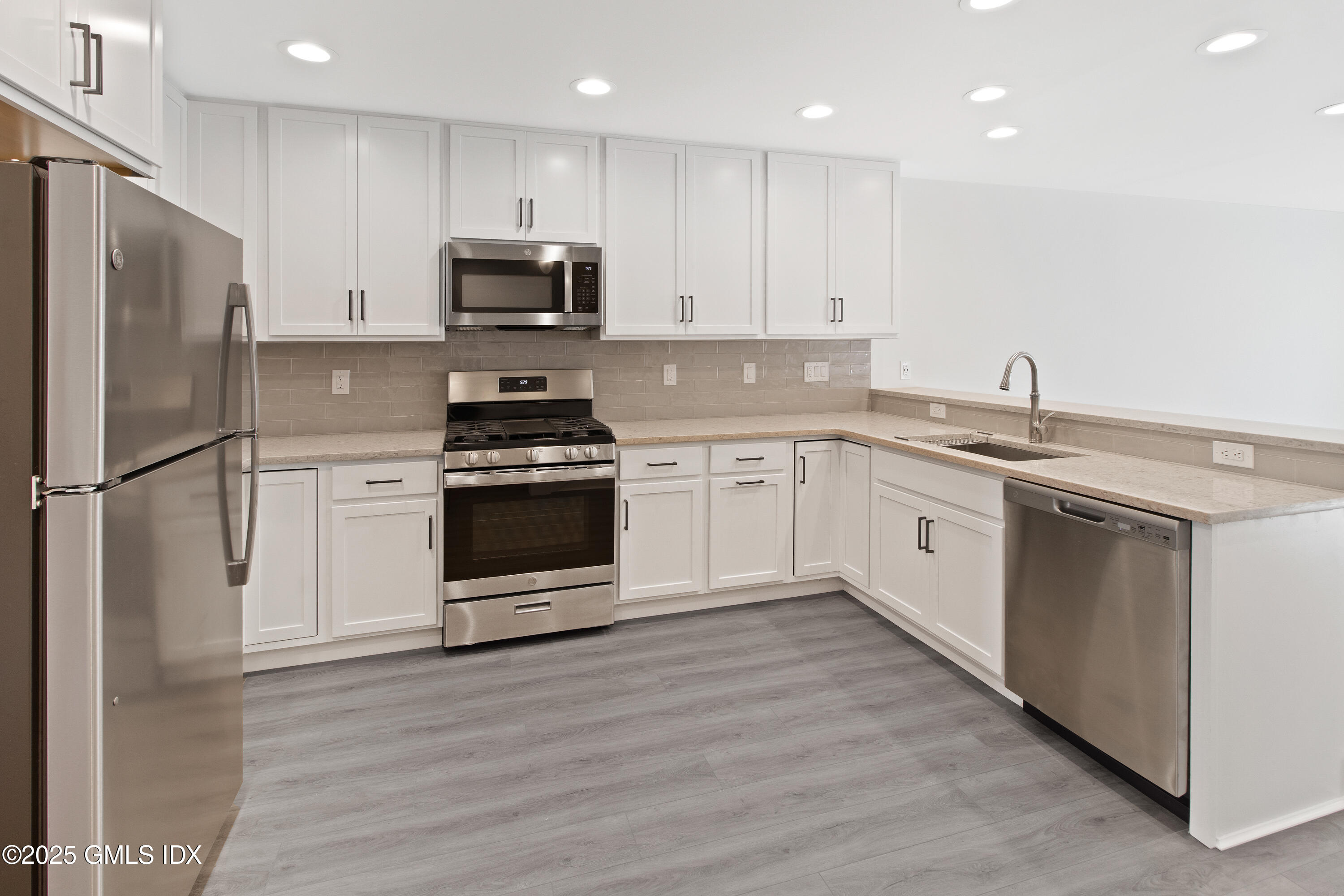 4 Orchard Street, Unit N Cos Cob, CT 06807 - Photo 4 of 17 a kitchen with a sink stainless steel appliances and cabinets