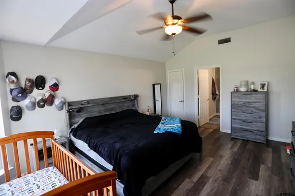 a bedroom with a bed and wooden floor