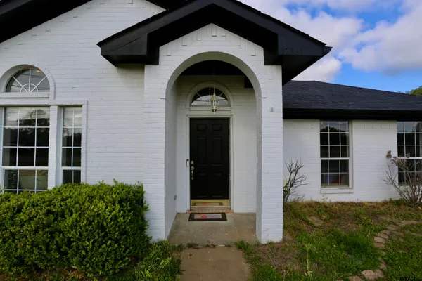 a view of a brick house with large windows
