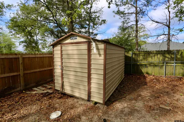 a view of a wooden house with a yard
