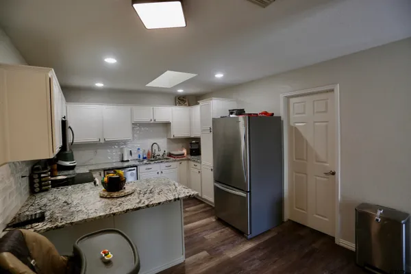 a kitchen with refrigerator and window