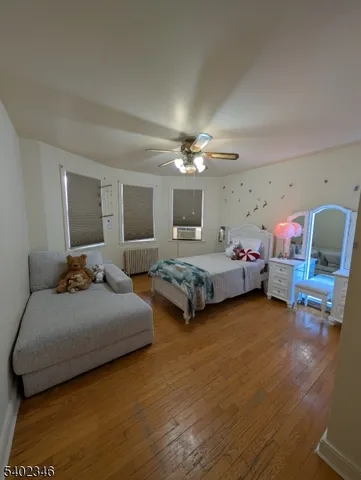 a bedroom with a bed couch and window