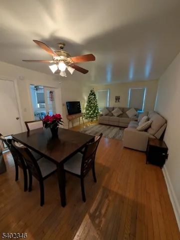 a view of a dining room with furniture and a chandelier