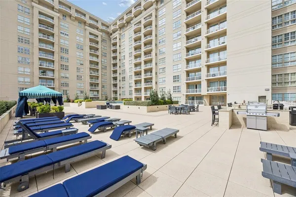 a swimming pool with outdoor seating and a buildings view