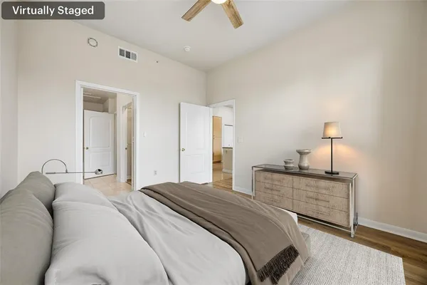 a bedroom with a bed and a chandelier