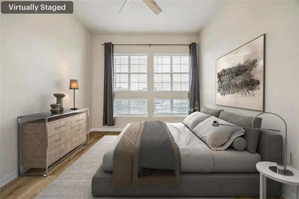 a spacious bedroom with a bed and a large window