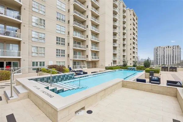 a view of a swimming pool with a lounge chairs