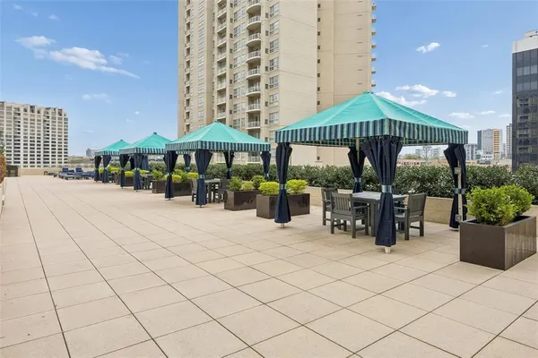 a view of a patio with a table and chairs under an umbrella
