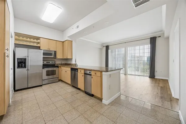 a kitchen with stainless steel appliances a refrigerator and a stove top oven