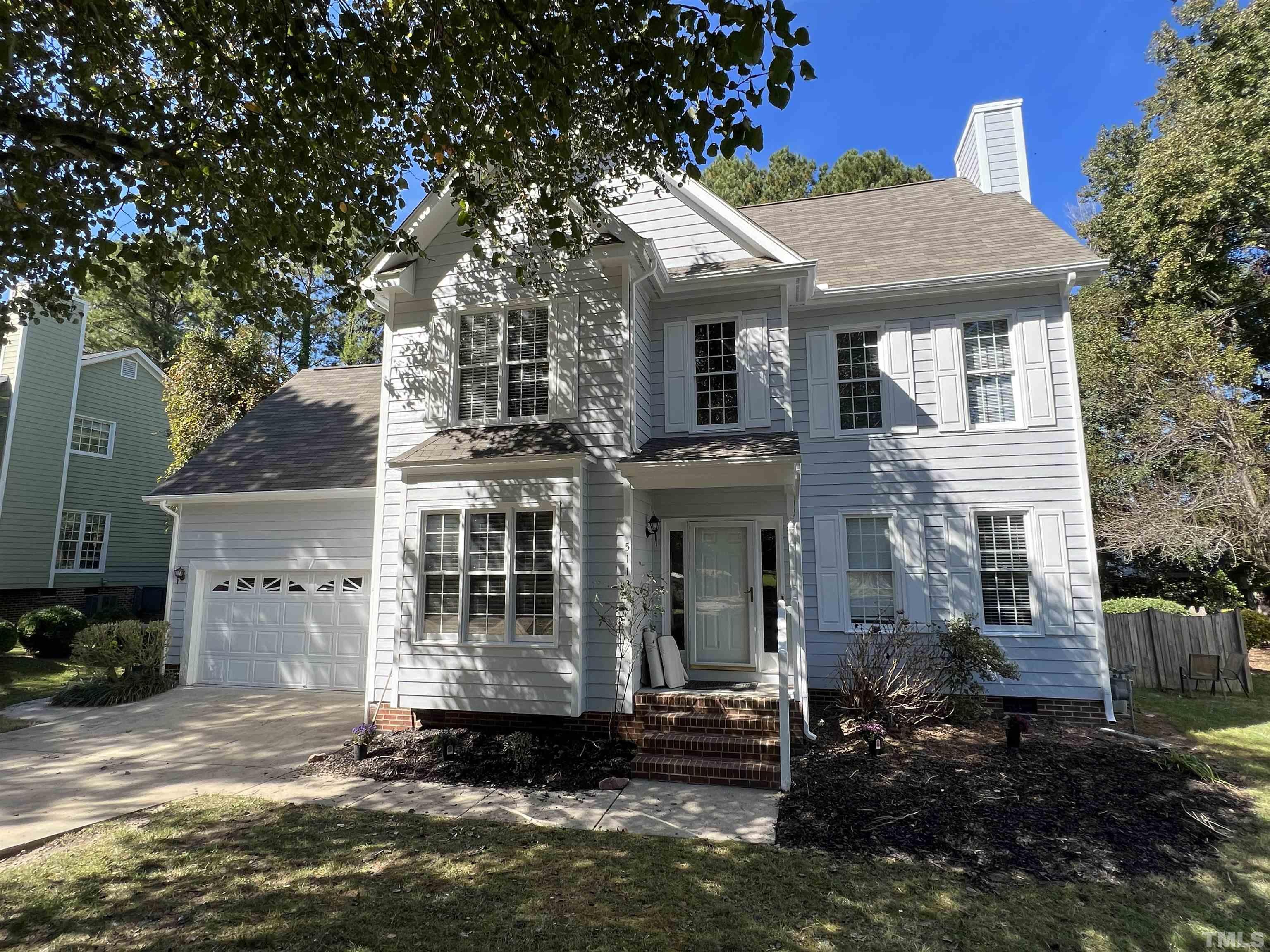 5113 Six Point Trail Raleigh, NC 27616 - Photo 14 of 53 a view of a white house with large windows and a small yard