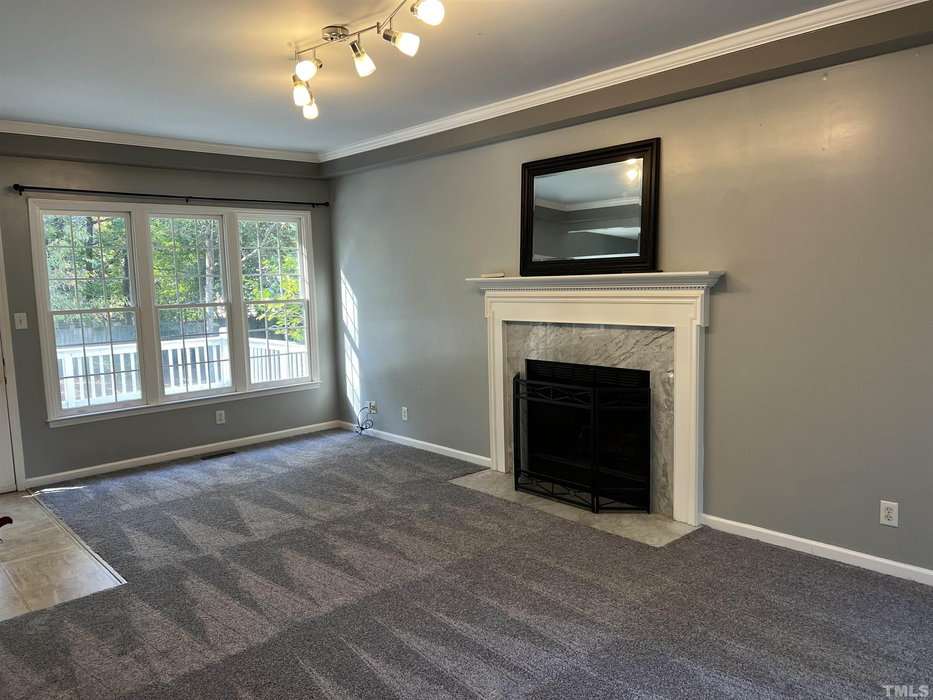 5113 Six Point Trail Raleigh, NC 27616 - Photo 19 of 53 a view of an empty room with a fireplace and a window