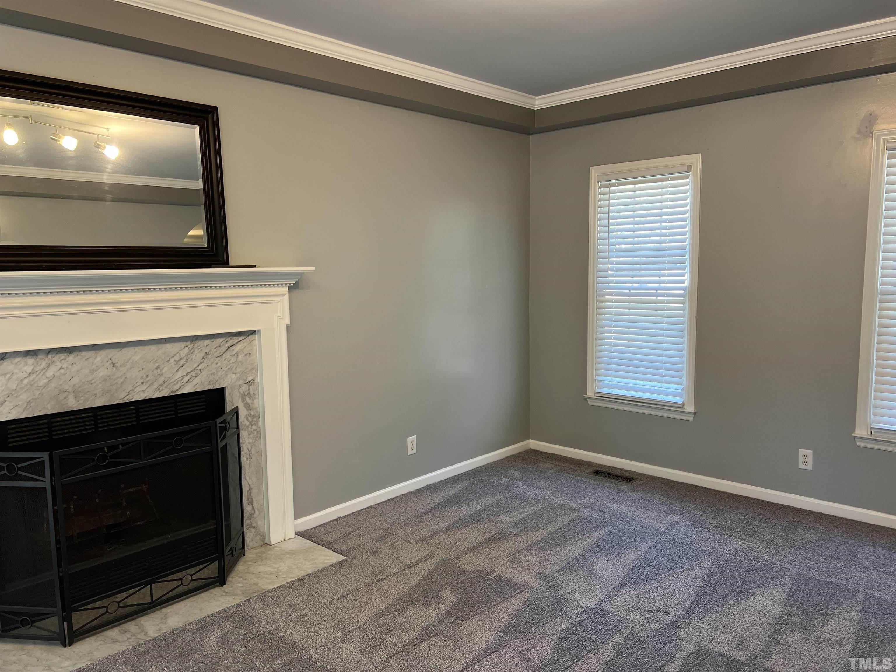 5113 Six Point Trail Raleigh, NC 27616 - Photo 49 of 53 a view of an empty room with a fireplace and a window
