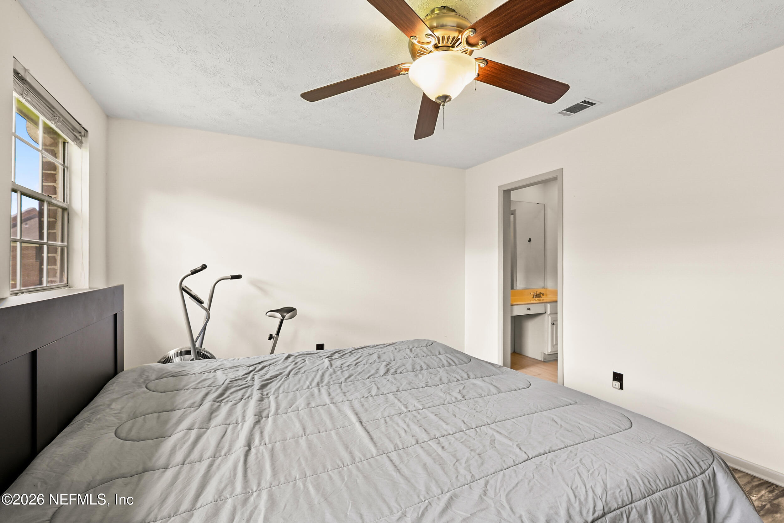 4915 Baymeadows Road, Unit 6G Jacksonville, FL 32217 - Photo 19 of 44 a bedroom with a bed and a chandelier