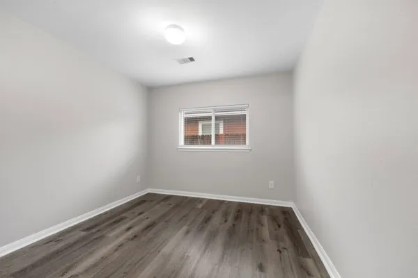 a view of a room with wooden floor and white walls