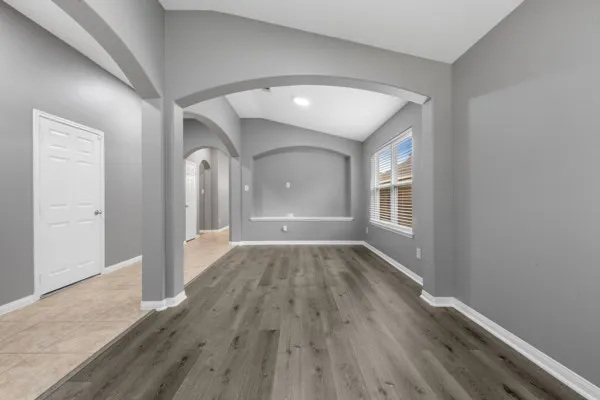 wooden floor in an empty room with a window
