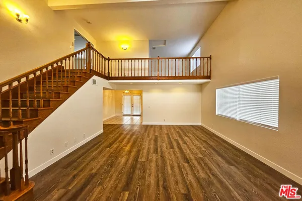 a view of balcony with wooden floor and staircase