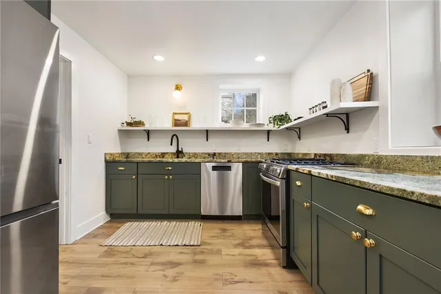 a bathroom with a sink toilet mirror and shower