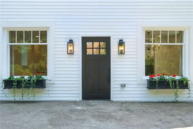 a living room with furniture wooden floor and a large window