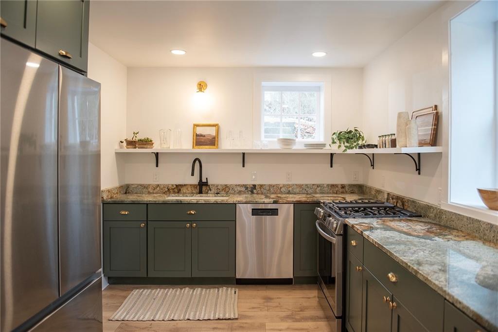 4978 South Pioneer Road Gibsonia, PA 15044 - Photo 26 of 49 a kitchen with stainless steel appliances granite countertop a sink stove and refrigerator