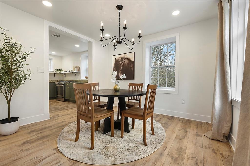 4978 South Pioneer Road Gibsonia, PA 15044 - Photo 28 of 49 a dining room with wooden floor a chandelier a wooden table and chairs