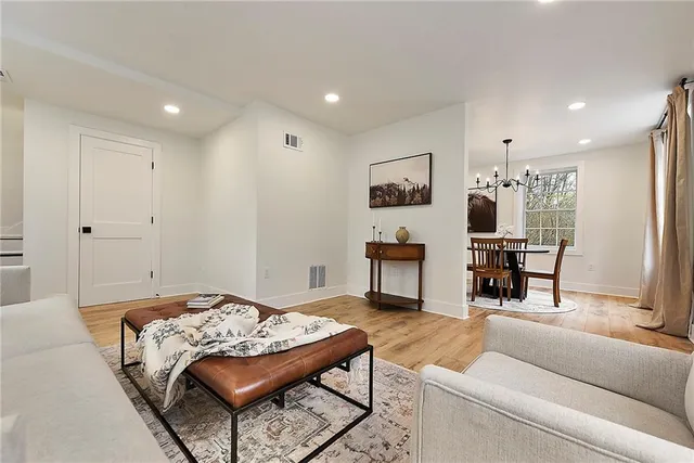 a living room with furniture and a wooden floor
