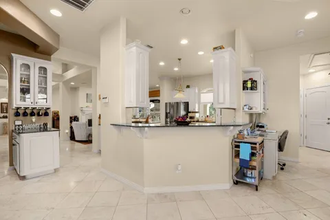 a dining room with furniture a chandelier and a rug