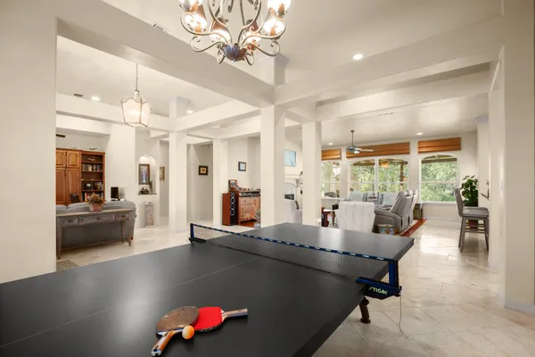 a living room with furniture and a chandelier