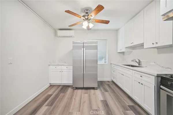 a kitchen with cabinets stainless steel appliances and a window