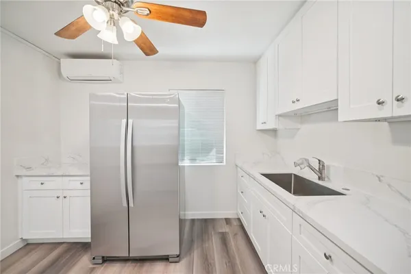 a kitchen with a refrigerator sink and cabinets