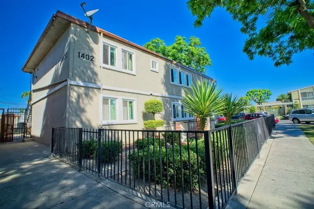 a view of a house with a small yard and plants
