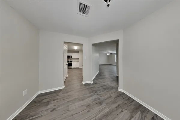 a view of a room with wooden floor