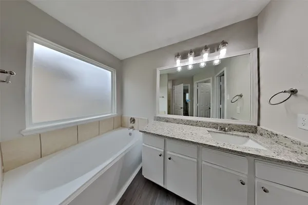 a bathroom with a double vanity sink and a mirror