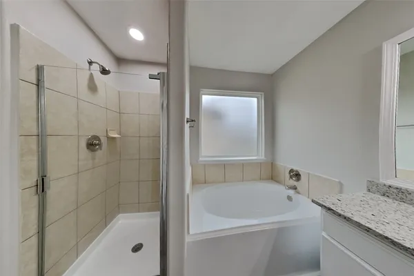 a bathroom with a granite countertop sink a toilet and shower