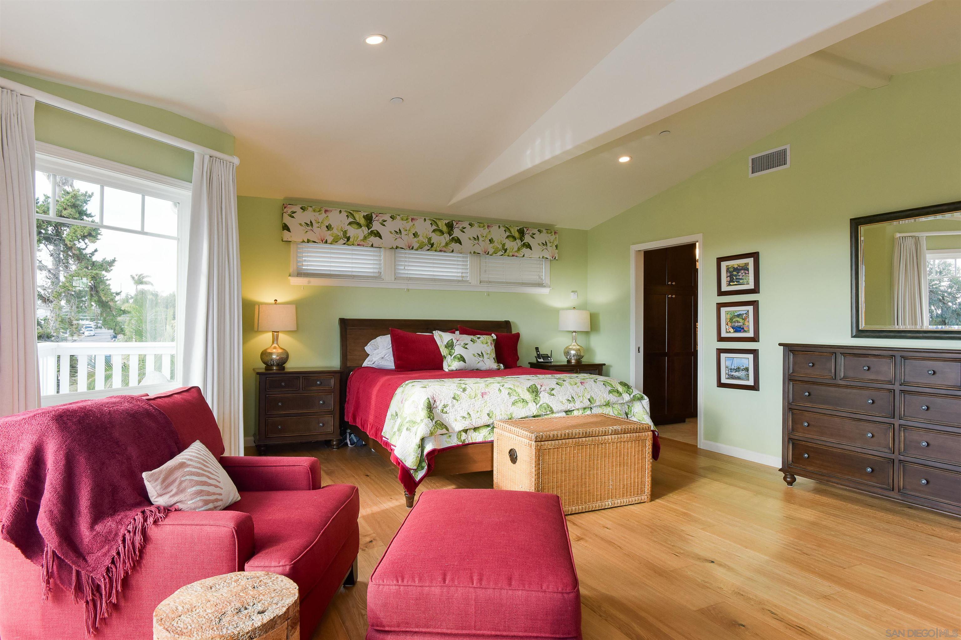 222 Barbara Avenue Solana Beach, CA 92075 - Photo 14 of 37 a bedroom with a bed and wooden floor