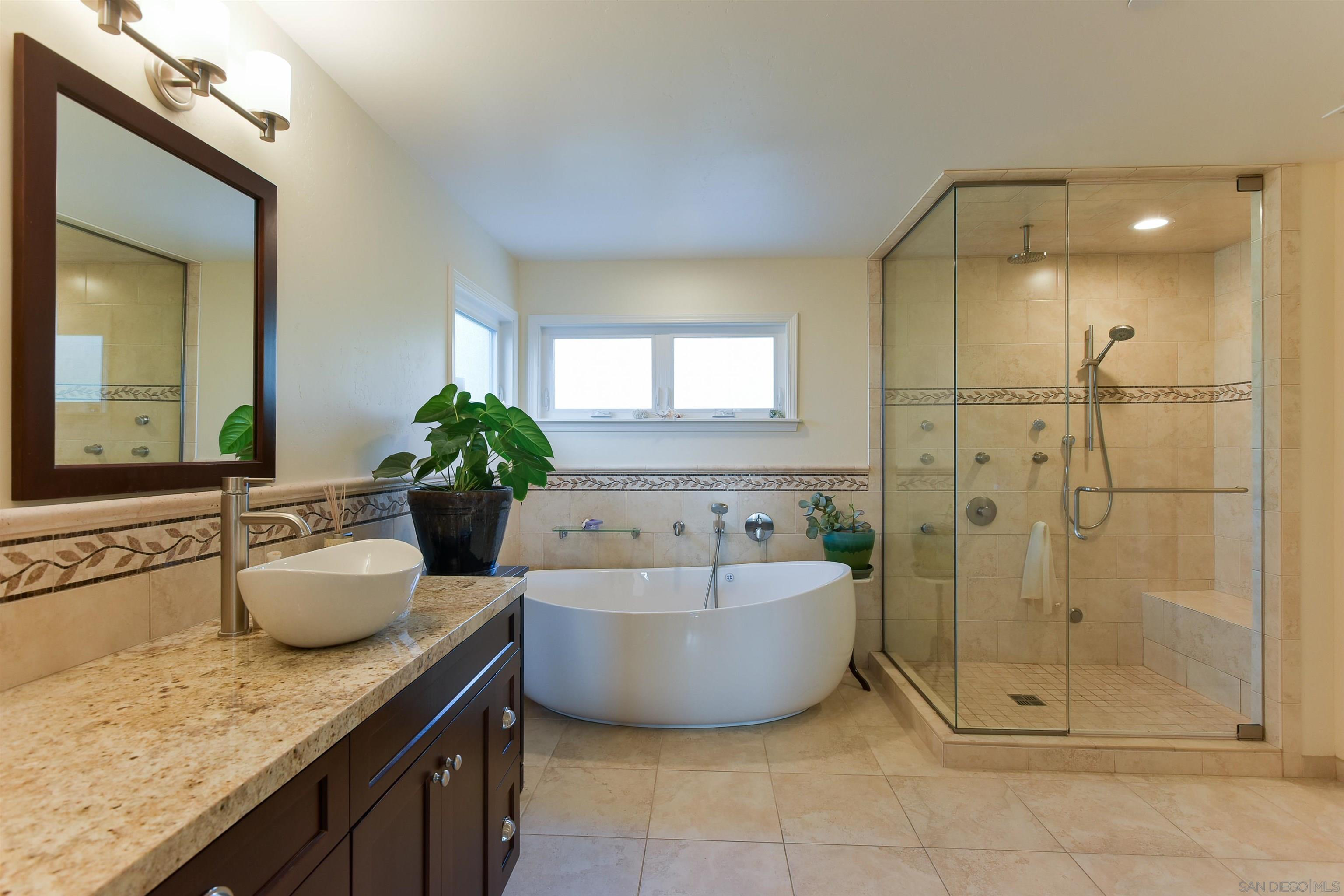 222 Barbara Avenue Solana Beach, CA 92075 - Photo 15 of 37 a spacious bathroom with a granite countertop sink mirror and bathtub