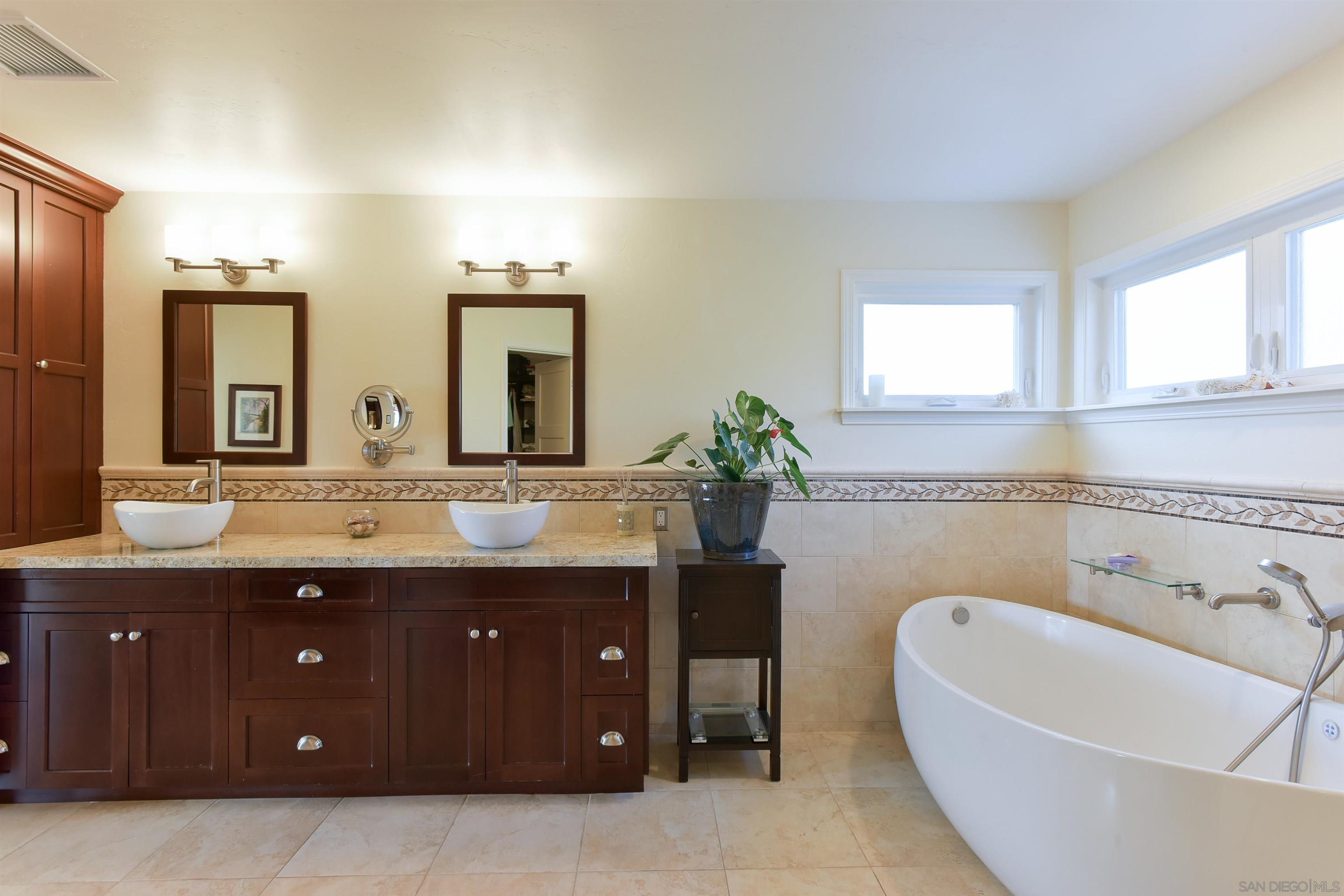 222 Barbara Avenue Solana Beach, CA 92075 - Photo 17 of 37 a spacious bathroom with a granite countertop sink and a bathtub