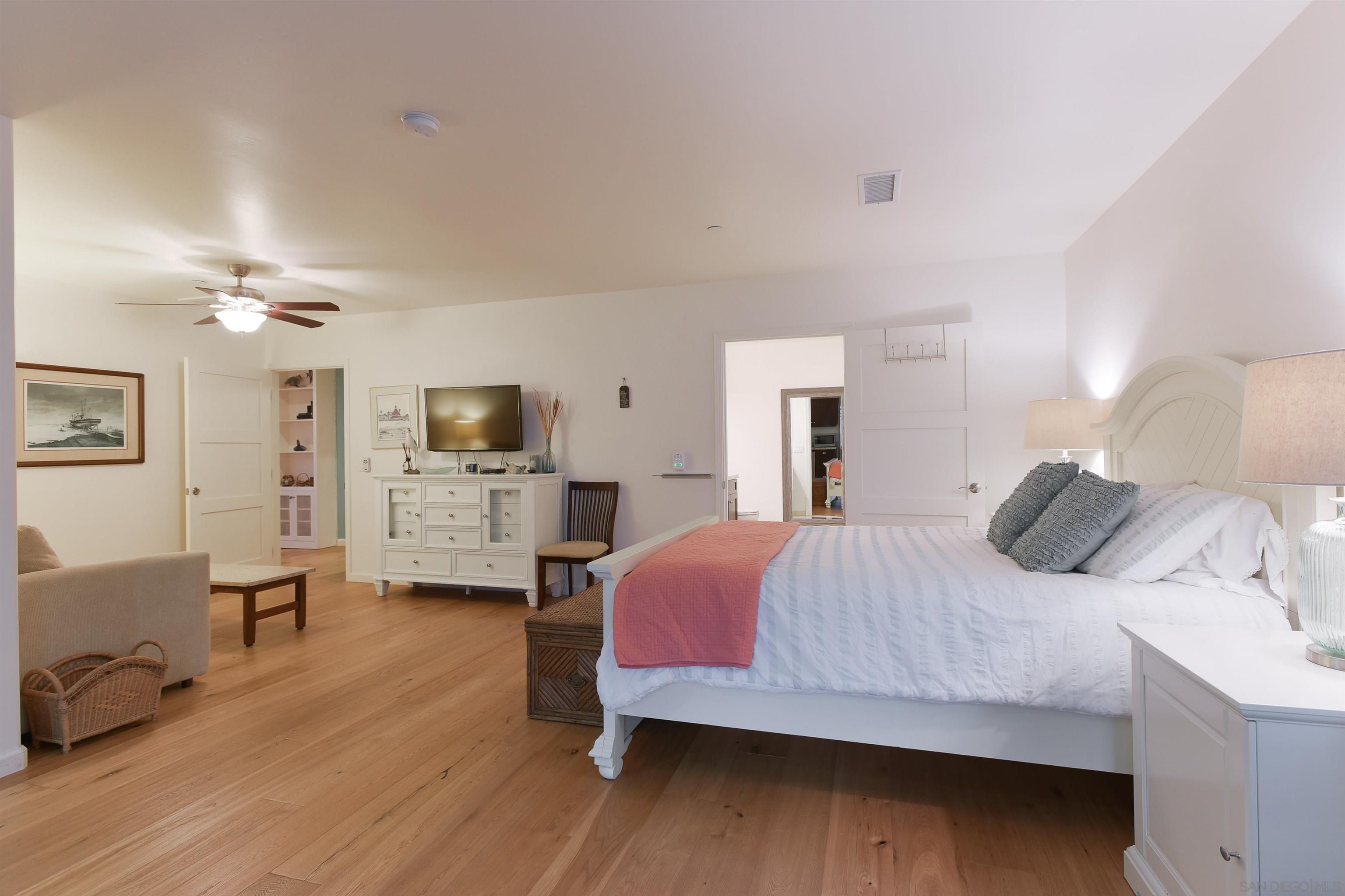 222 Barbara Avenue Solana Beach, CA 92075 - Photo 18 of 37 a bedroom with a bed wooden floor and furniture