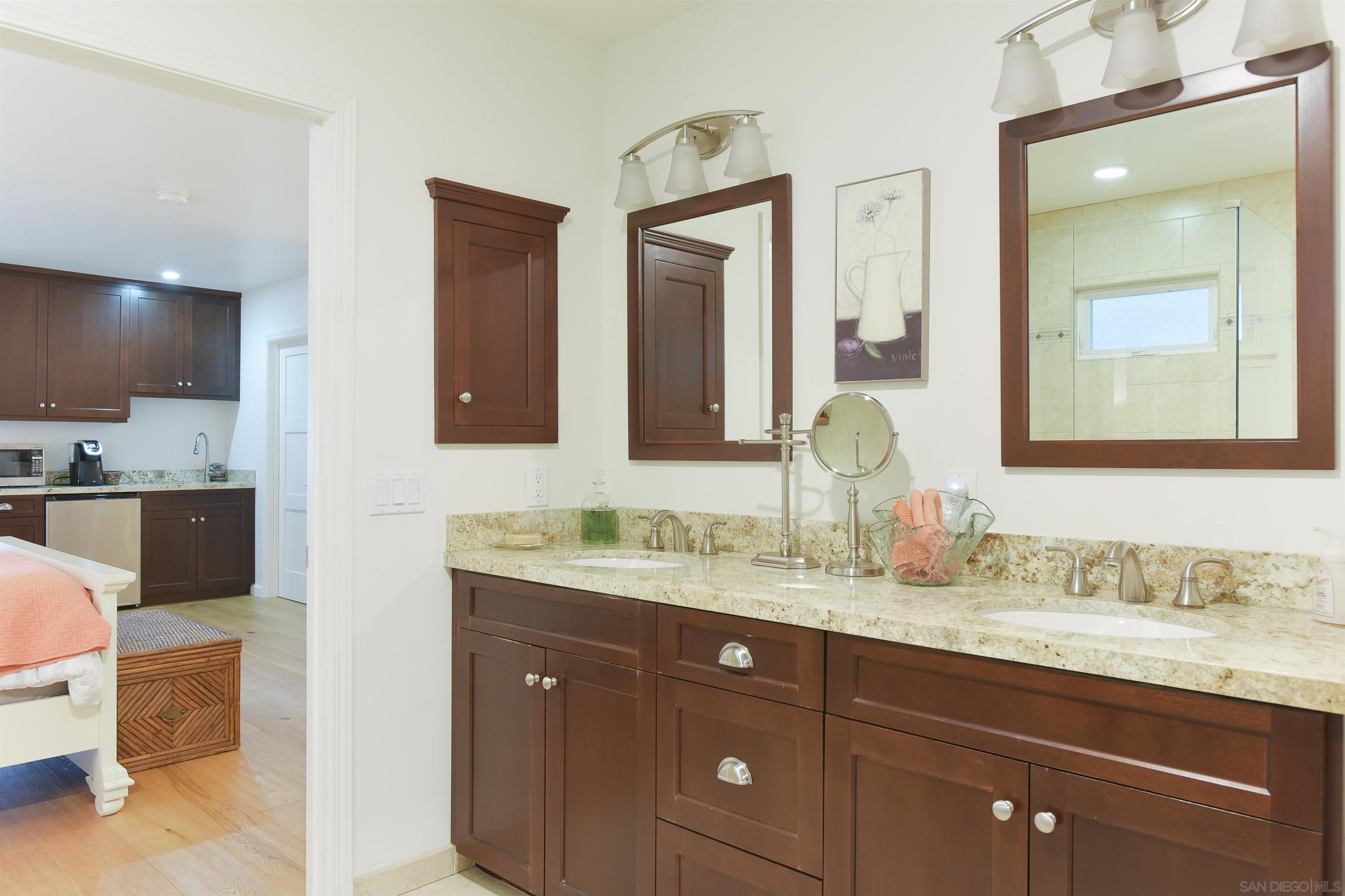 222 Barbara Avenue Solana Beach, CA 92075 - Photo 19 of 37 a bathroom with a granite countertop double vanity sink and a mirror