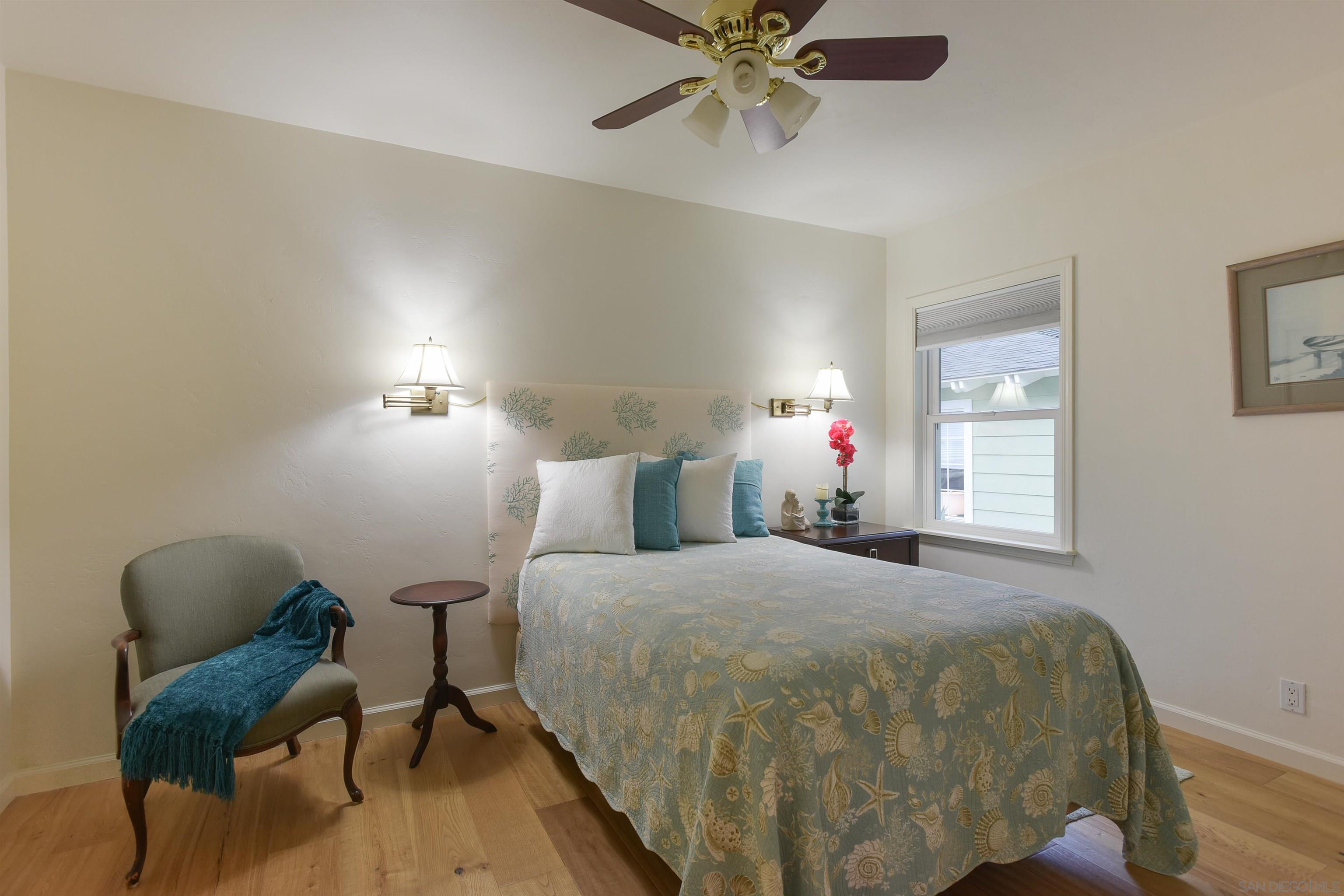 222 Barbara Avenue Solana Beach, CA 92075 - Photo 20 of 37 a bedroom with a bed and a chandelier