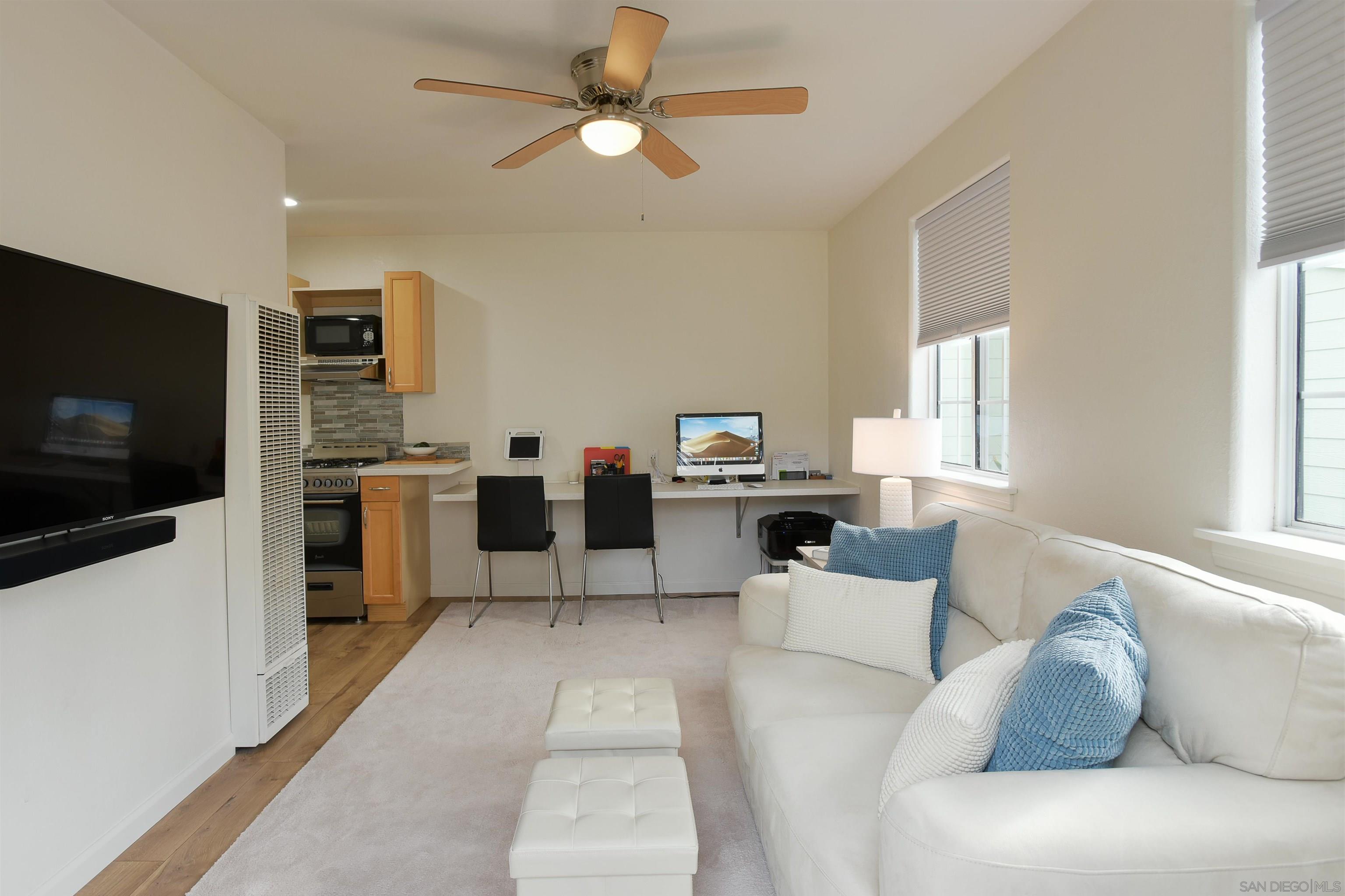 222 Barbara Avenue Solana Beach, CA 92075 - Photo 25 of 37 a living room with furniture and a flat screen tv
