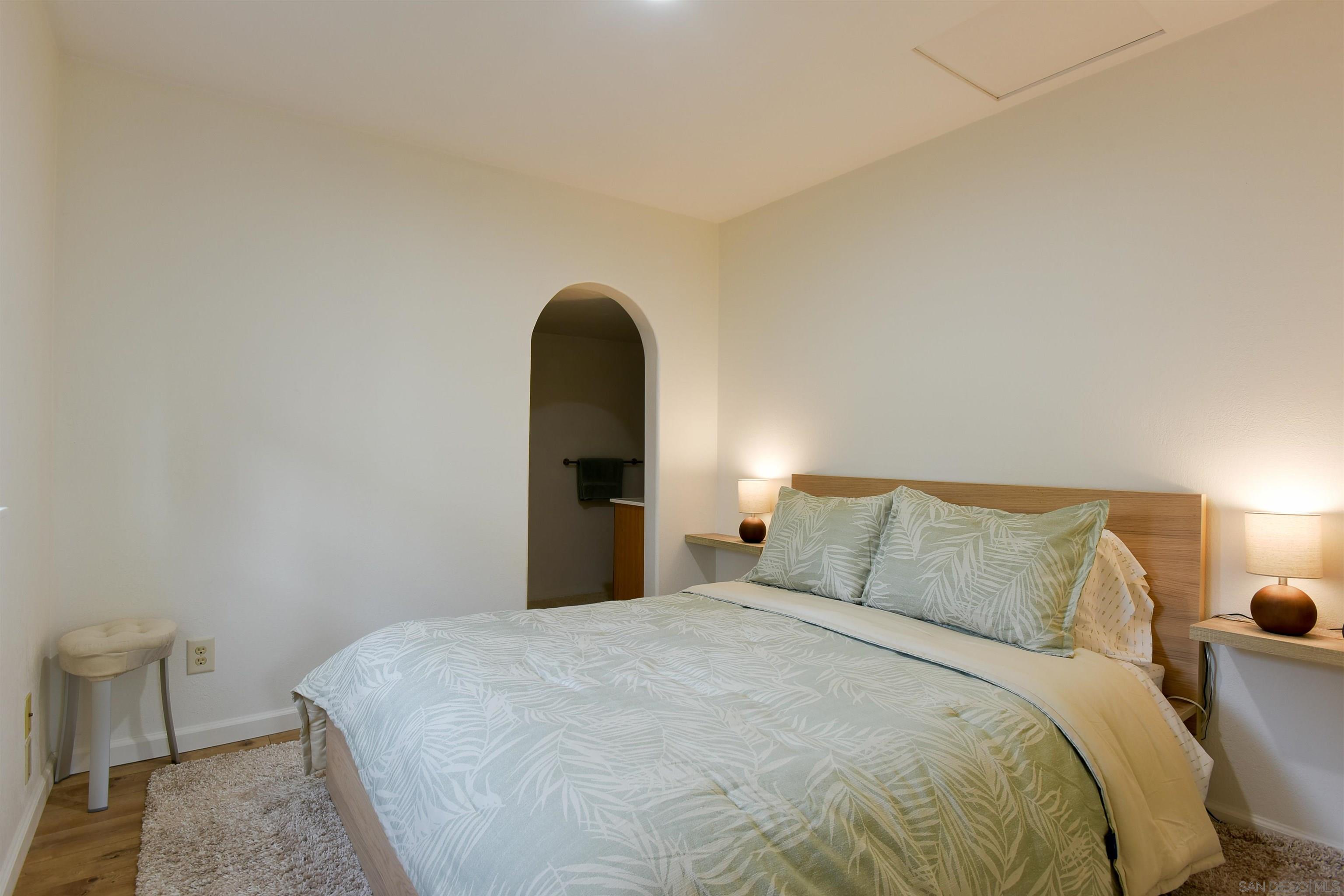 222 Barbara Avenue Solana Beach, CA 92075 - Photo 28 of 37 a bedroom with a bed and a lamp