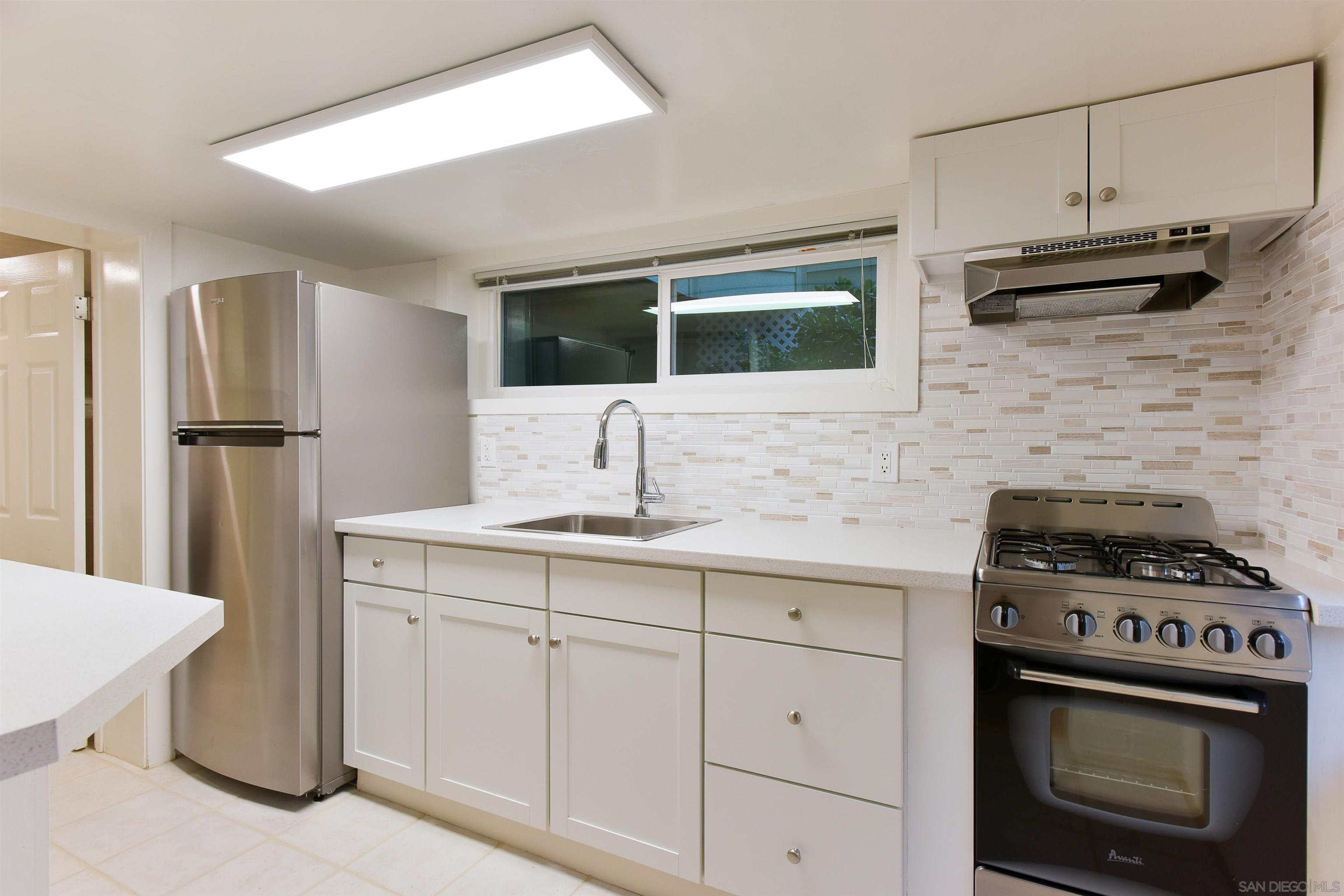222 Barbara Avenue Solana Beach, CA 92075 - Photo 30 of 37 a kitchen with cabinets stainless steel appliances and sink