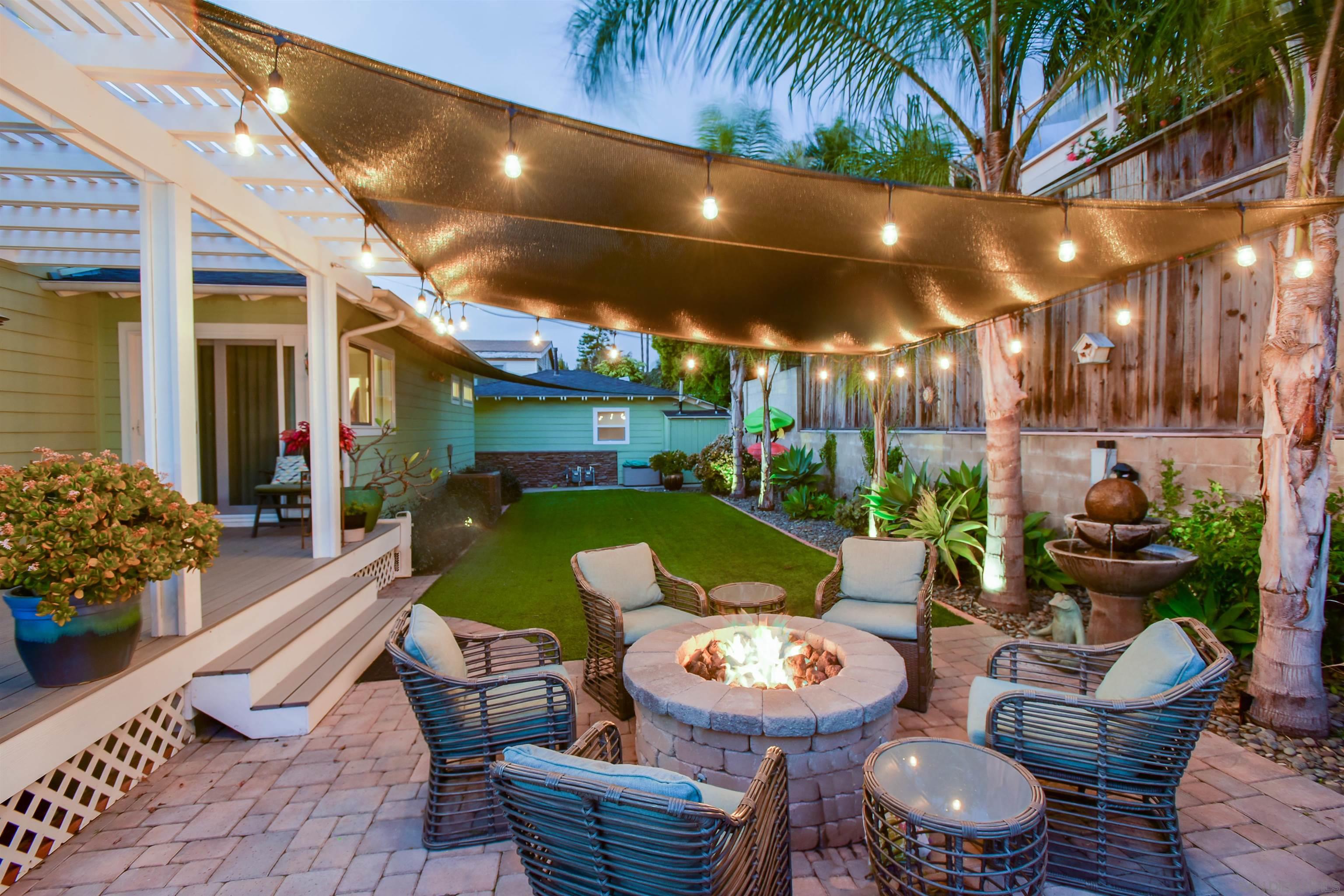 222 Barbara Avenue Solana Beach, CA 92075 - Photo 35 of 37 a view of a patio with couches table and chairs potted plants and palm trees