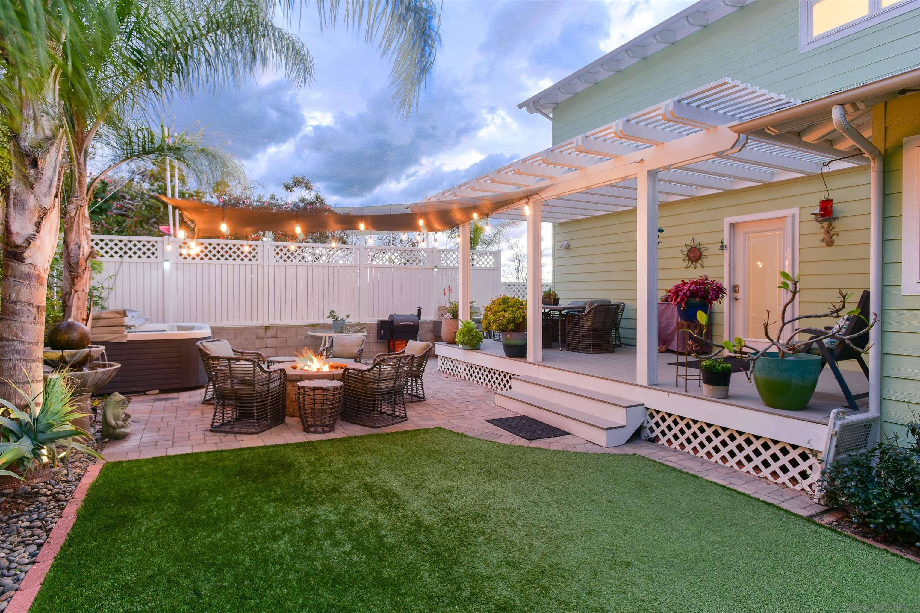 222 Barbara Avenue Solana Beach, CA 92075 - Photo 4 of 37 a view of a patio with table and chairs potted plants and palm trees