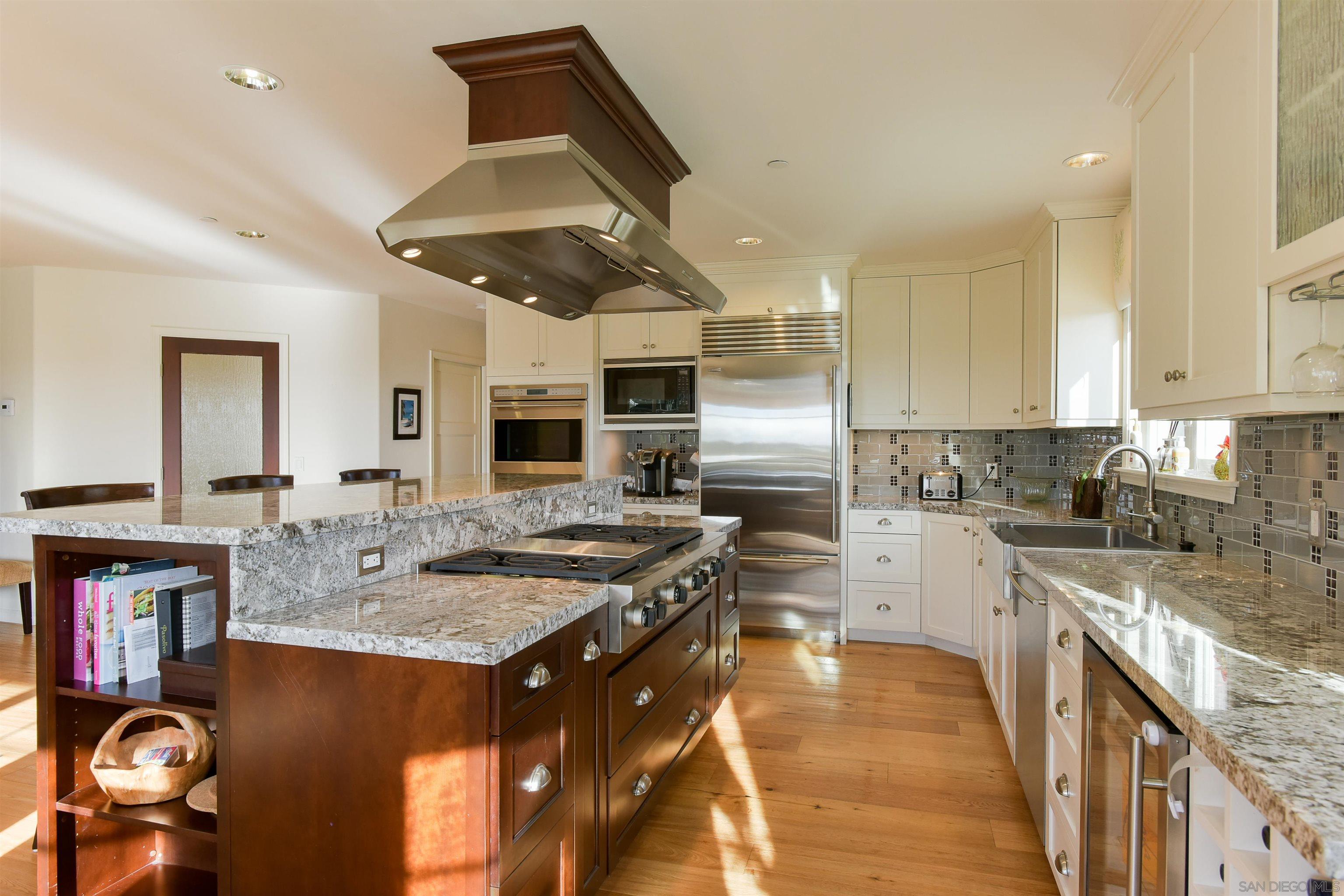 222 Barbara Avenue Solana Beach, CA 92075 - Photo 10 of 37 a kitchen with stainless steel appliances granite countertop a sink stove and refrigerator
