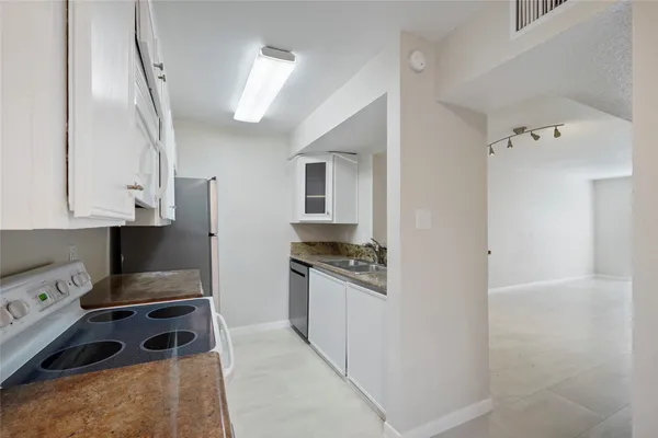 a kitchen with stainless steel appliances granite countertop a stove and a sink