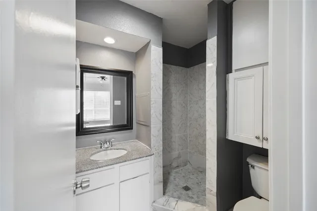 a bathroom with a sink toilet and shower