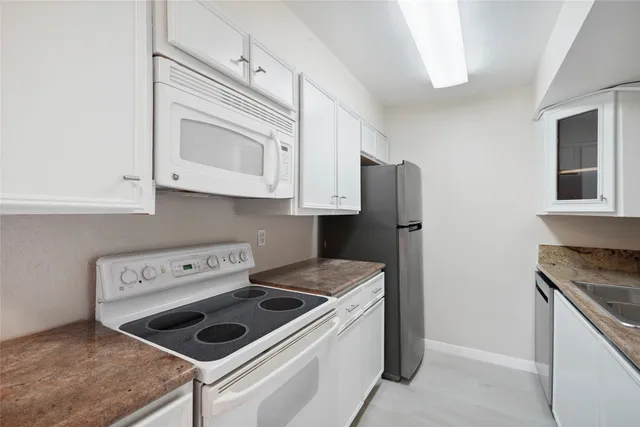 a kitchen with appliances cabinets and a counter top space