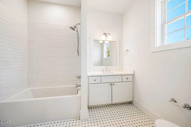a bathroom with a sink a mirror and a bathtub