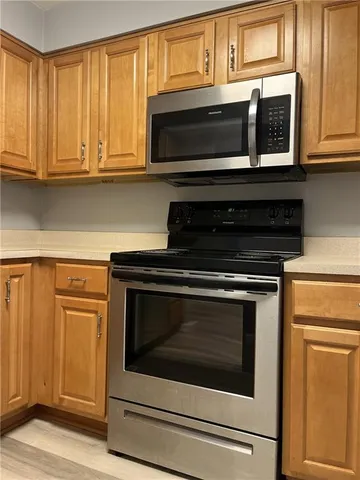 a stove top oven sitting inside of a kitchen
